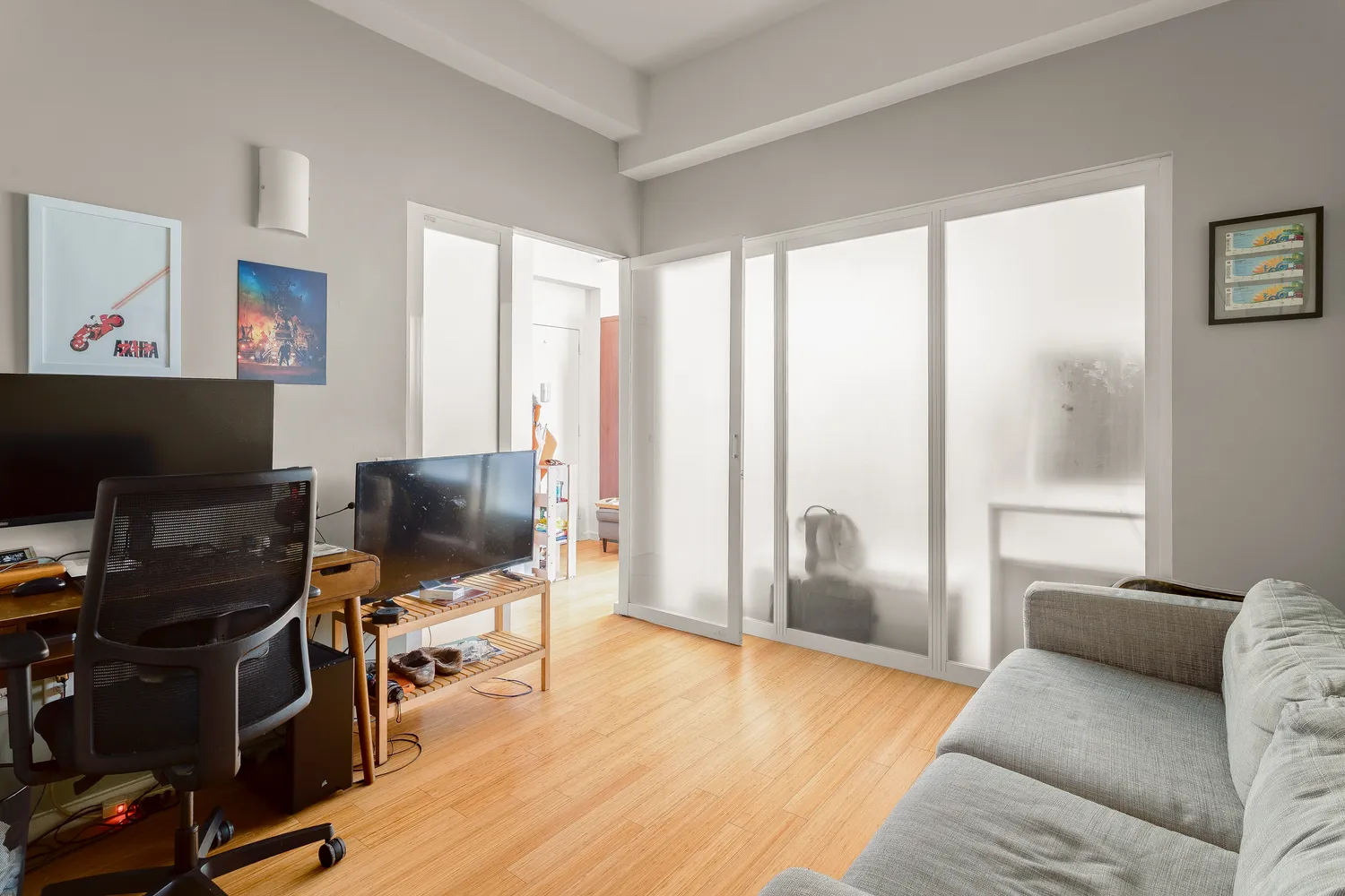 a livingroom with workspace and a window