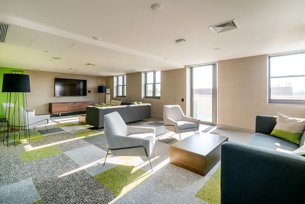 a living room with furniture wooden floor and a flat screen tv