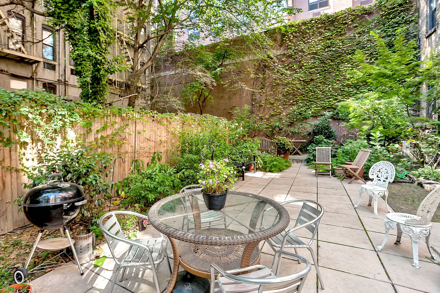 206 East 90th Street, Unit 2E Manhattan, NY 10128 - Photo 9 of 13 a view of outdoor dining space with a table and chairs and potted plants