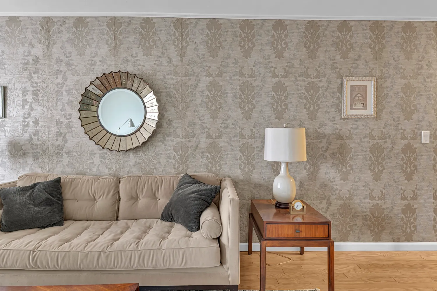 a living room with a couch and a potted plant
