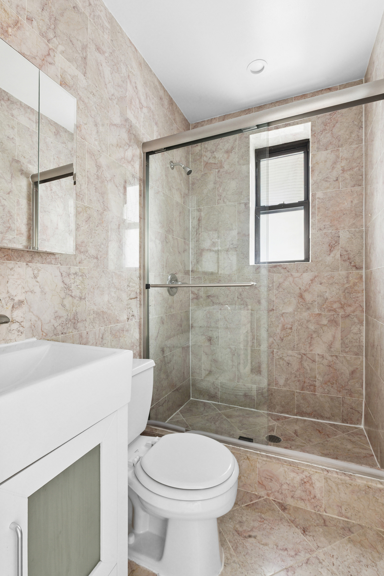 205 West 10th Street, Unit 3D Manhattan, NY 10014 - Photo 6 of 7 a bathroom with a sink a toilet and shower