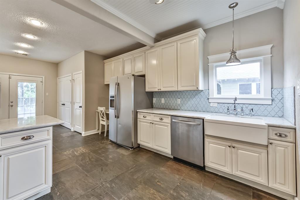 1120 Winston Street Houston, TX 77009 - Photo 12 of 29 a kitchen with white cabinets and white appliances