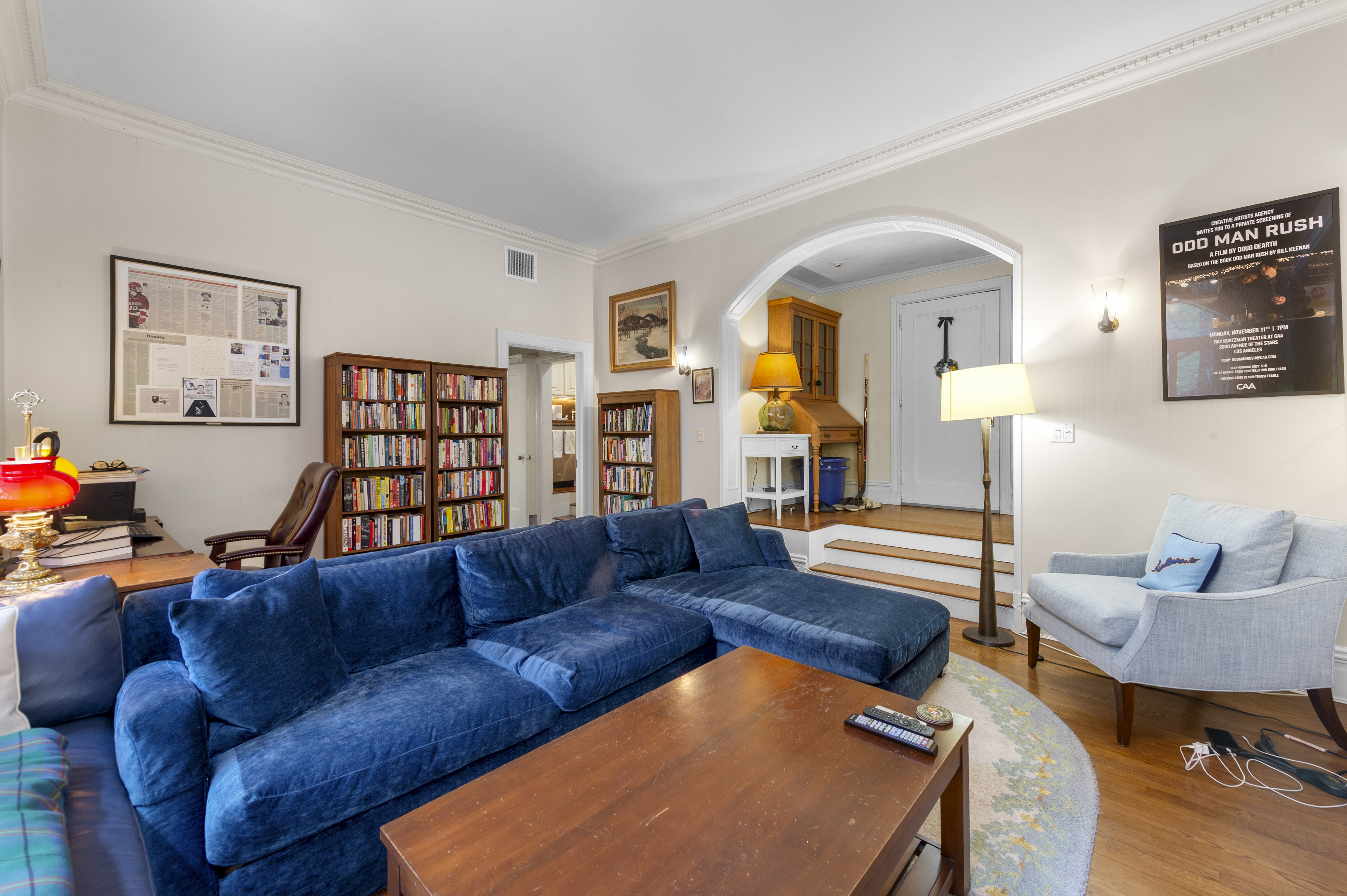 1 West 67th Street, Unit 2M Manhattan, NY 10023 - Photo 3 of 15 a living room with furniture and a wooden floor