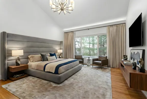 a bedroom with a bed and a flat screen tv