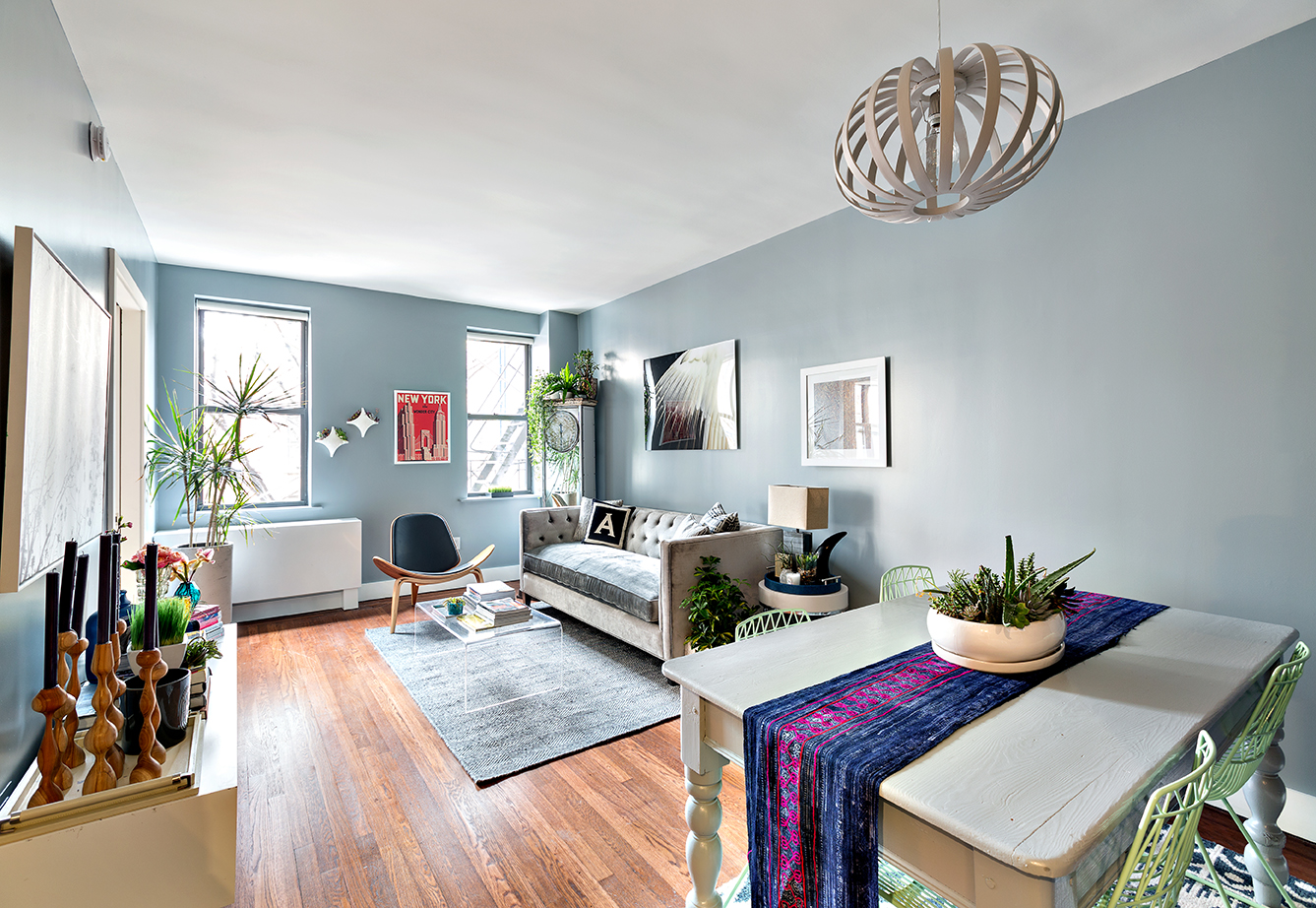 245 West 25th Street, Unit 1E Manhattan, NY 10001 - Photo 1 of 13 a view of a dining room with furniture a potted plant and wooden floor