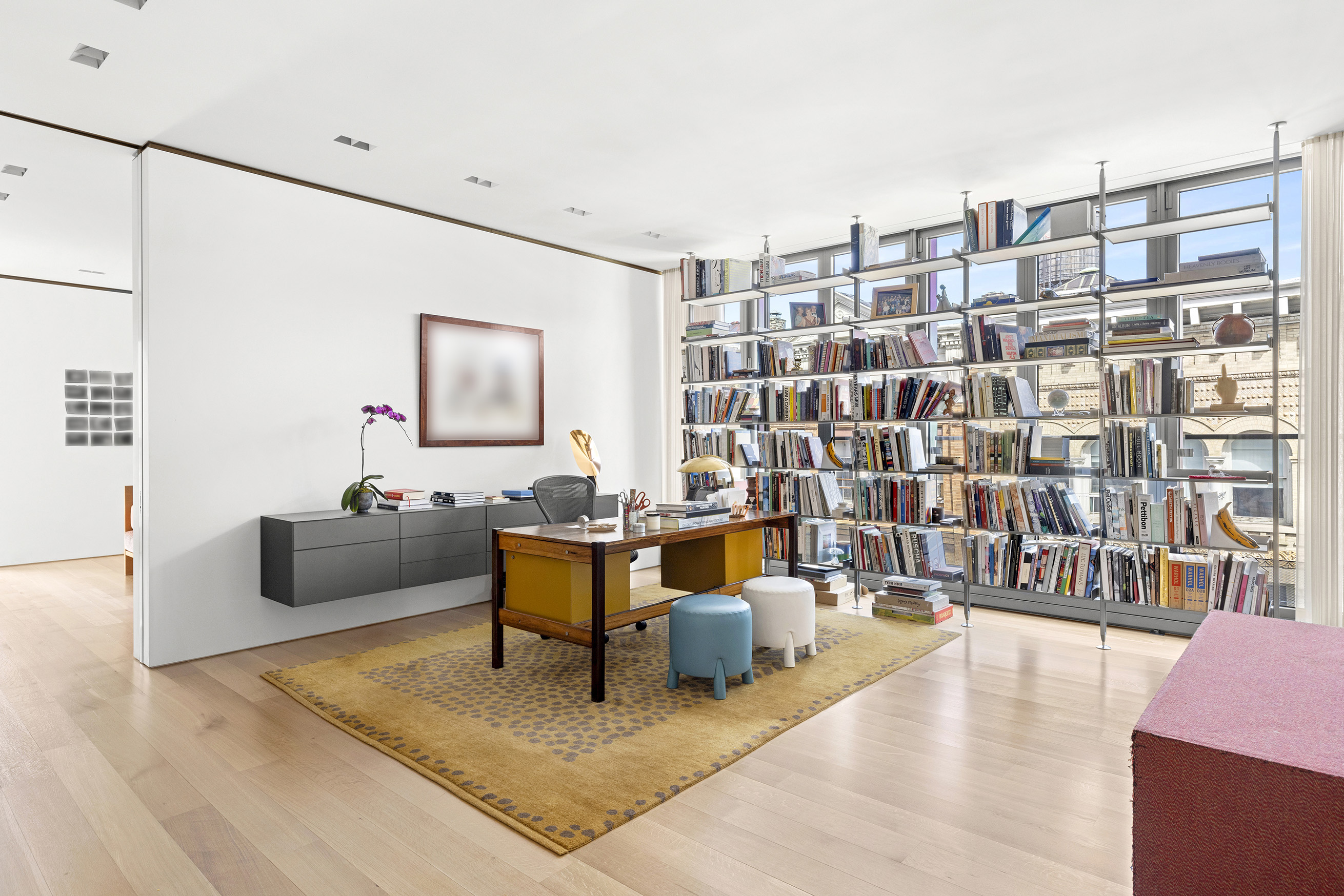 27 Wooster Street, Unit PH Manhattan, NY 10013 - Photo 25 of 34 a living room with furniture and a book shelf