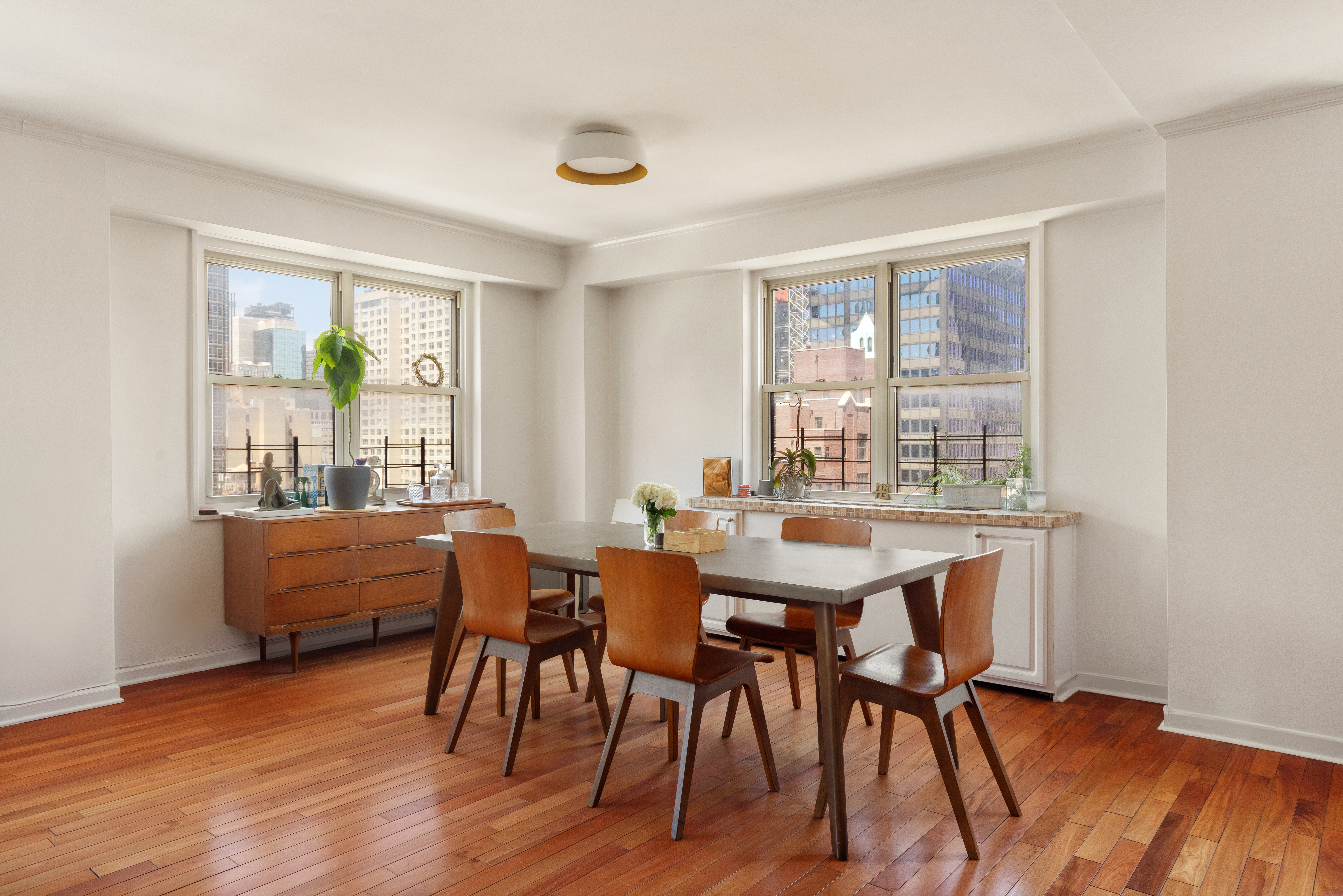 400 East 54th Street, Unit 21CDE Manhattan, NY 10022 - Photo 2 of 10 a dining room with furniture and wooden floor