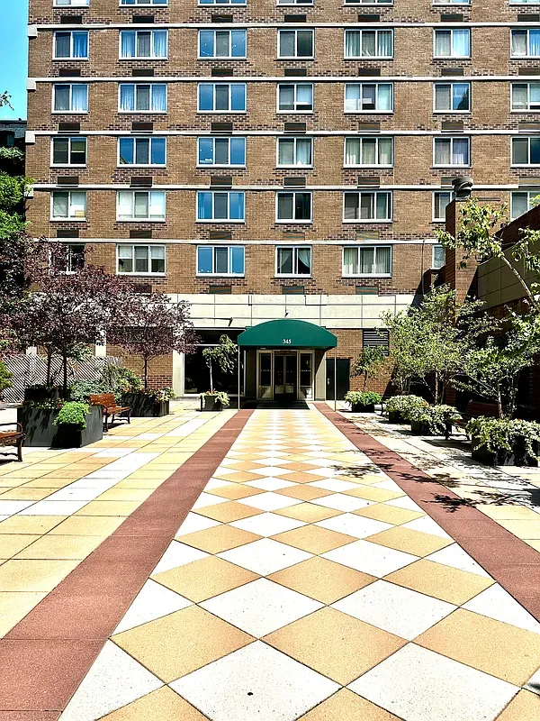 a front view of a building with a garden