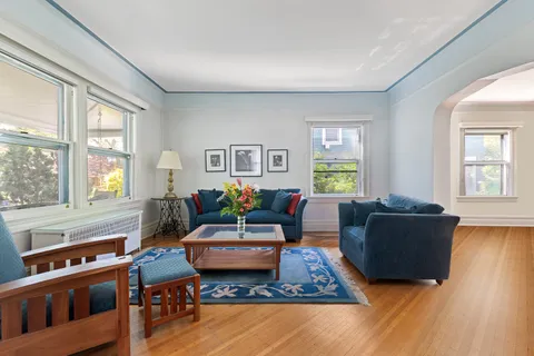 a living room with furniture and wooden floor