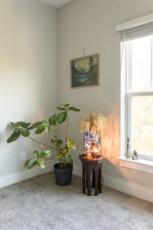 a vase of flowers sitting on a floor