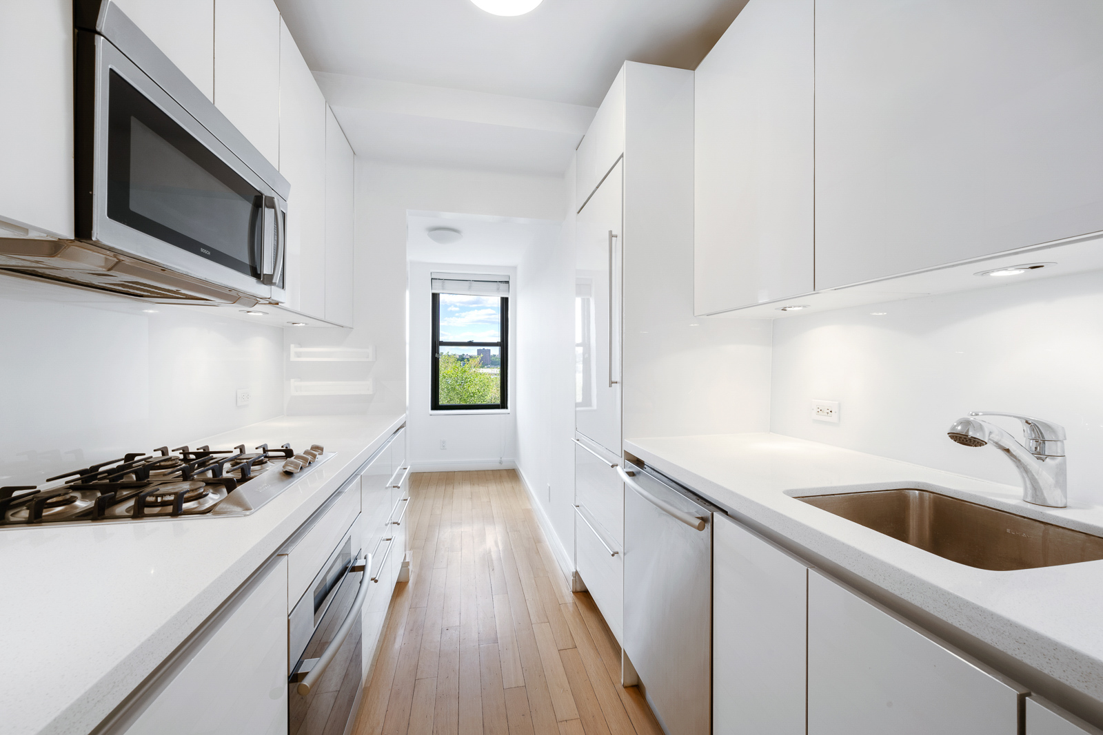 a kitchen that has a sink and a stove top oven