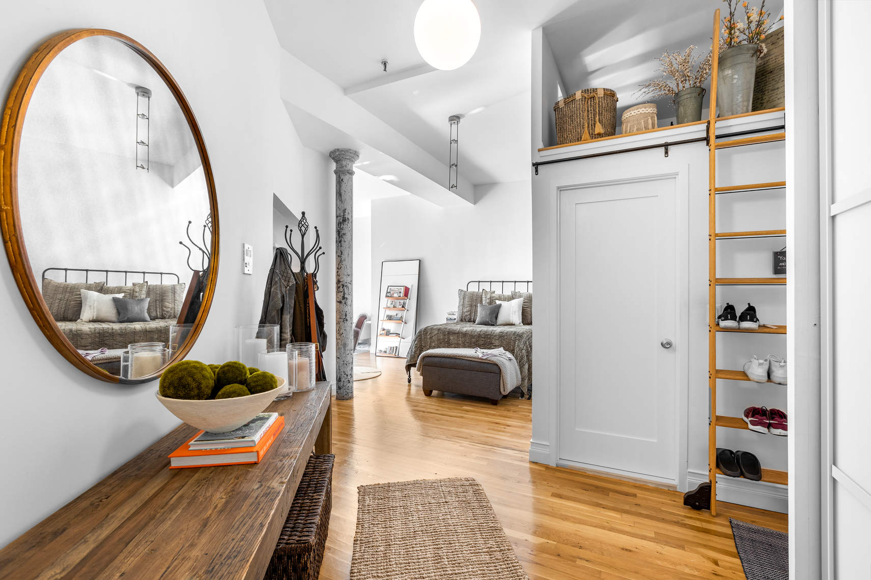 77 Bleecker Street, Unit 819 Manhattan, NY 10012 - Photo 2 of 9 a living room with furniture a rug and a wooden floor