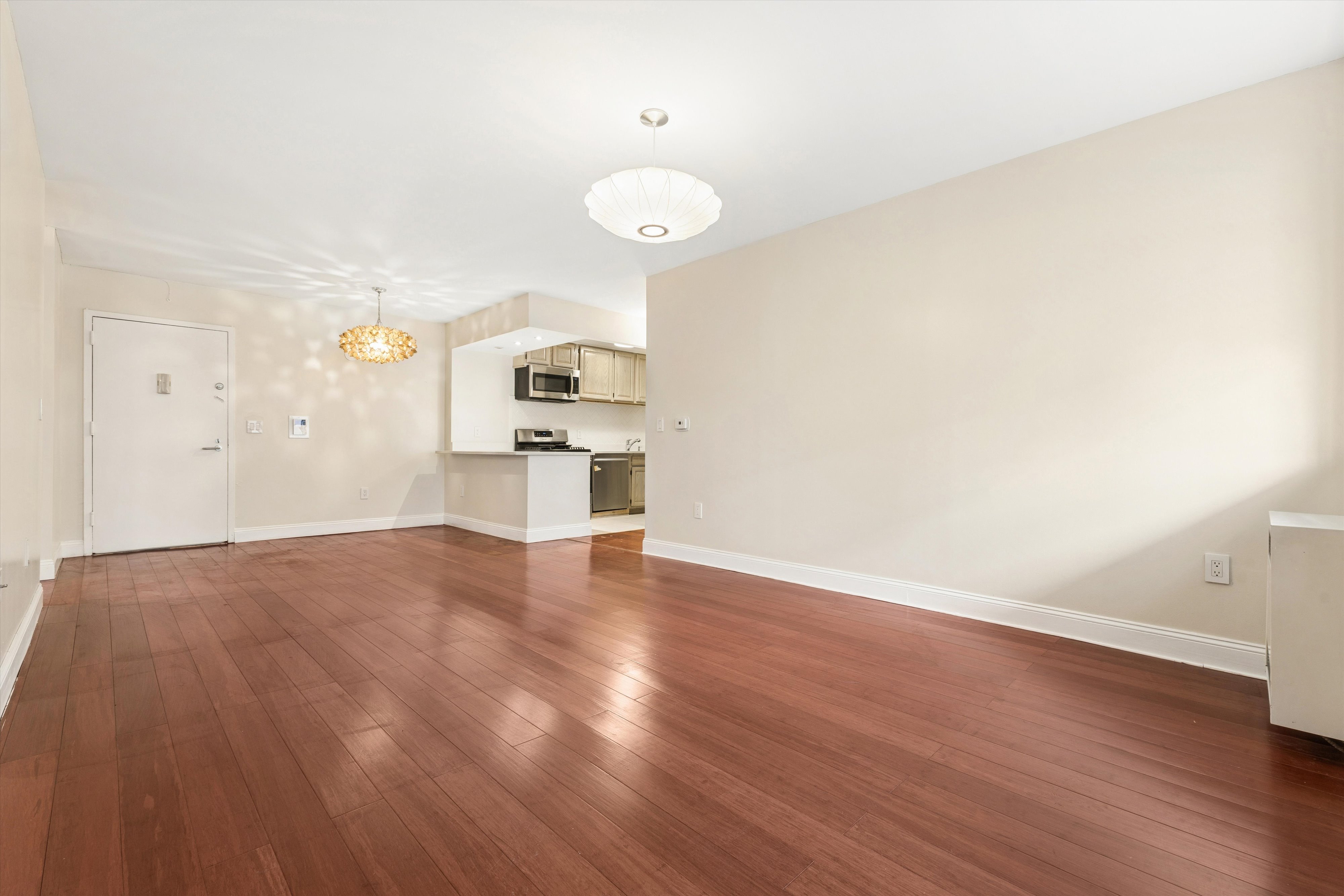 1919 Madison Avenue, Unit 418 Manhattan, NY 10035 - Photo 3 of 16 a view of a kitchen with a sink and dishwasher wooden floor