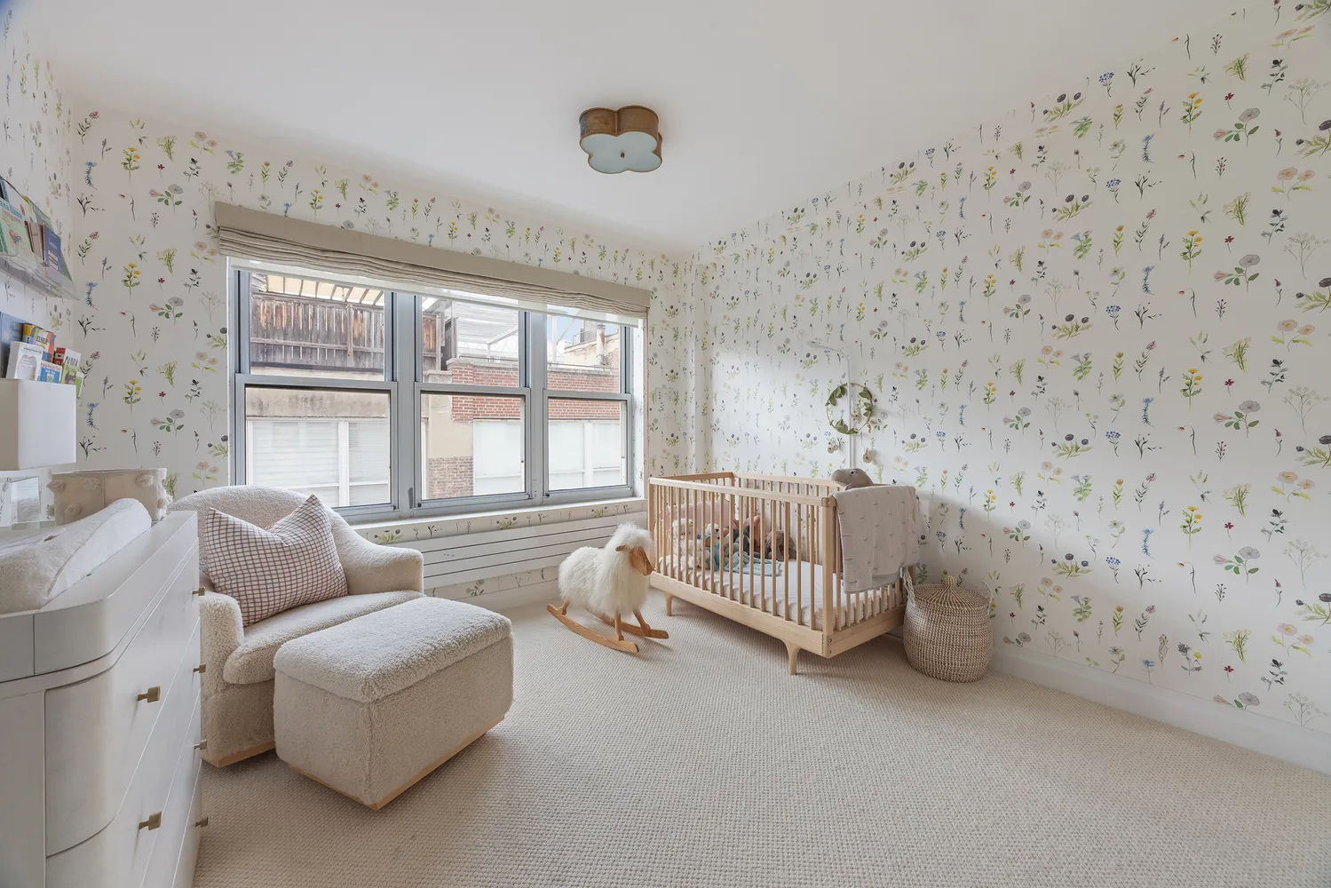 a bedroom with furniture and a large window