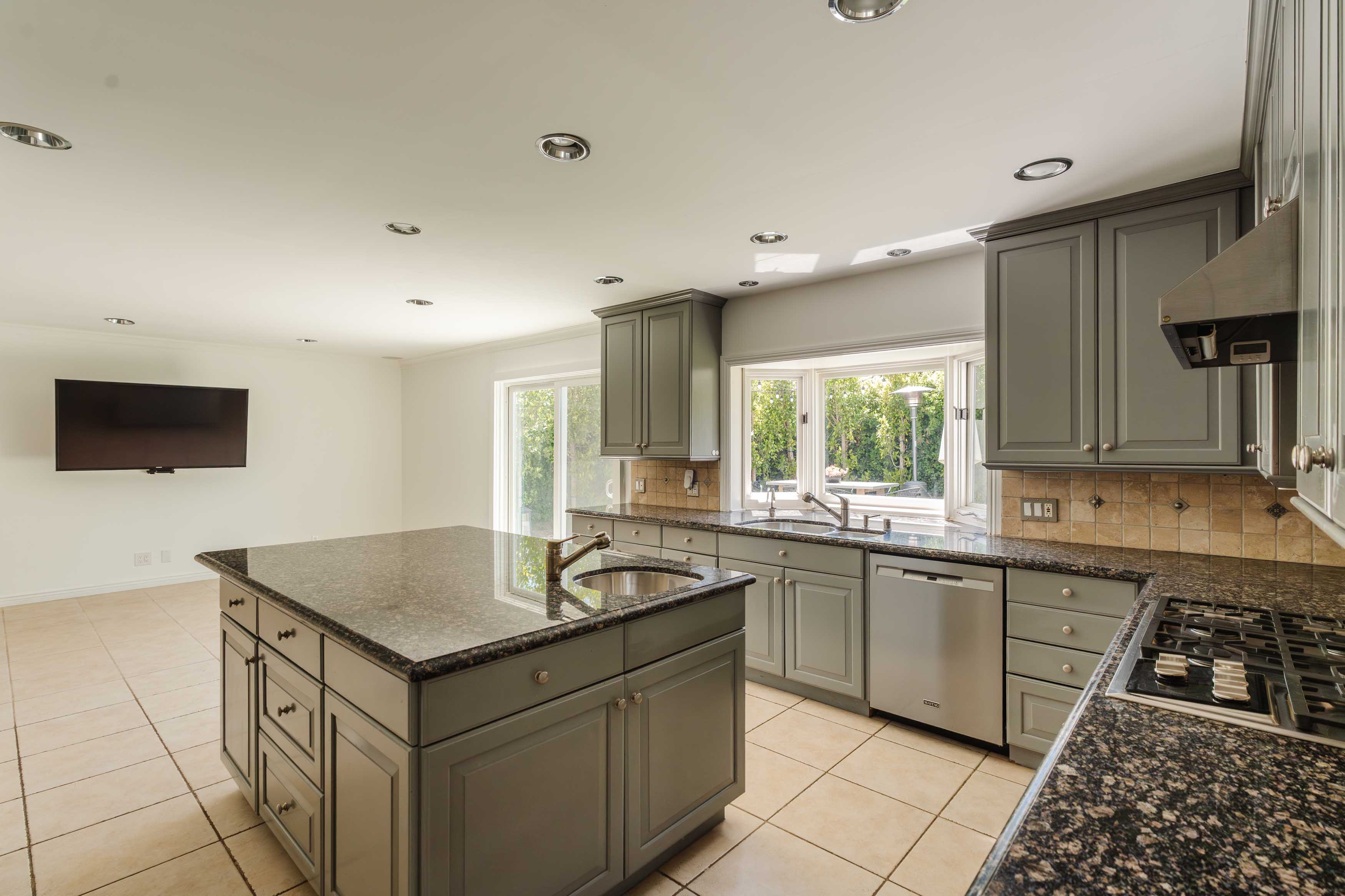 17273 Avenida De La Herradura Pacific Palisades, CA 90272 - Photo 7 of 23 a kitchen that has a sink and a stove in it