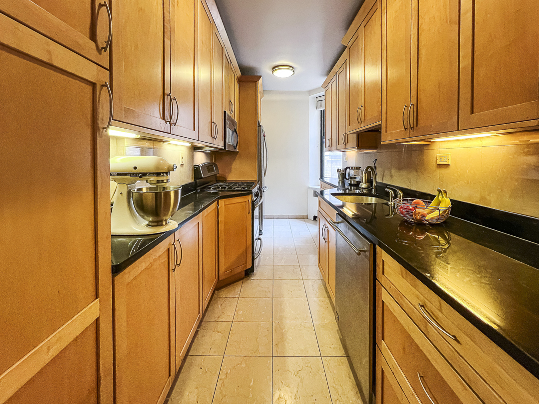 208 East 28th Street, Unit 4A Manhattan, NY 10016 - Photo 3 of 12 a kitchen with stainless steel appliances a sink and cabinets