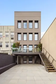 a view of a balcony with chairs and a barbeque