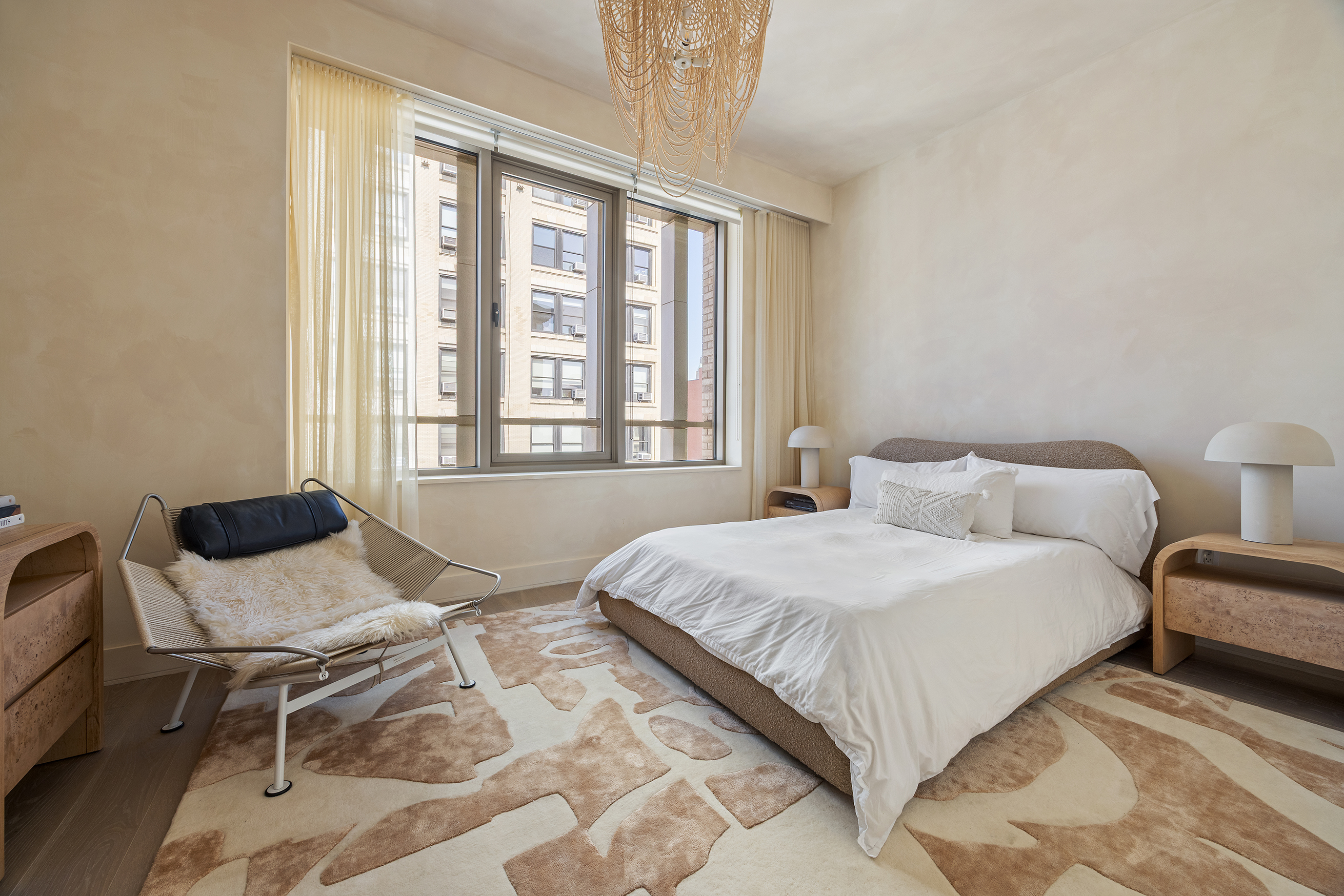 1 Great Jones Alley, Unit 10 Manhattan, NY 10012 - Photo 24 of 41 a bedroom with a bed and wooden floor