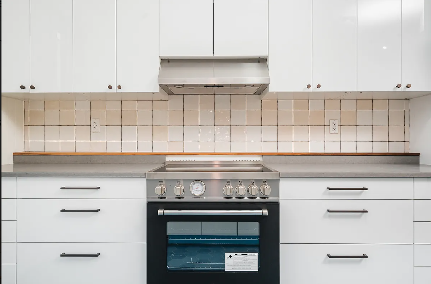 68-38 Forest Avenue, Unit 3R Queens, NY 11385 - Photo 6 of 15 a stove top oven sitting inside of a kitchen
