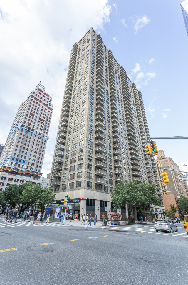 301 East 79th Street, Unit 18C Manhattan, NY 10075 - Photo 10 of 13 a front view of a building and a street