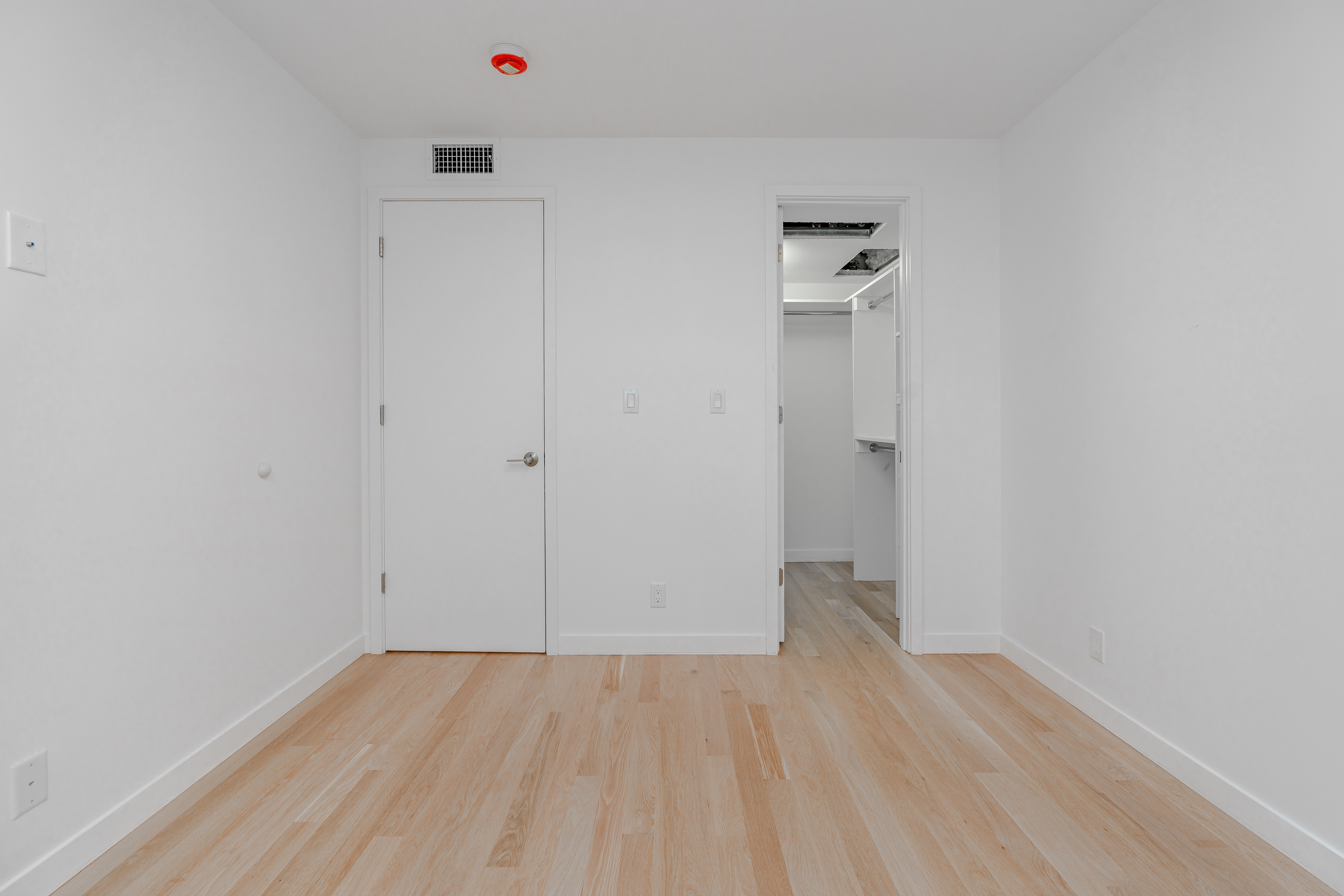 20-15 46th Street, Unit 2 Queens, NY 11105 - Photo 9 of 16 a view of a room with wooden floor and wall