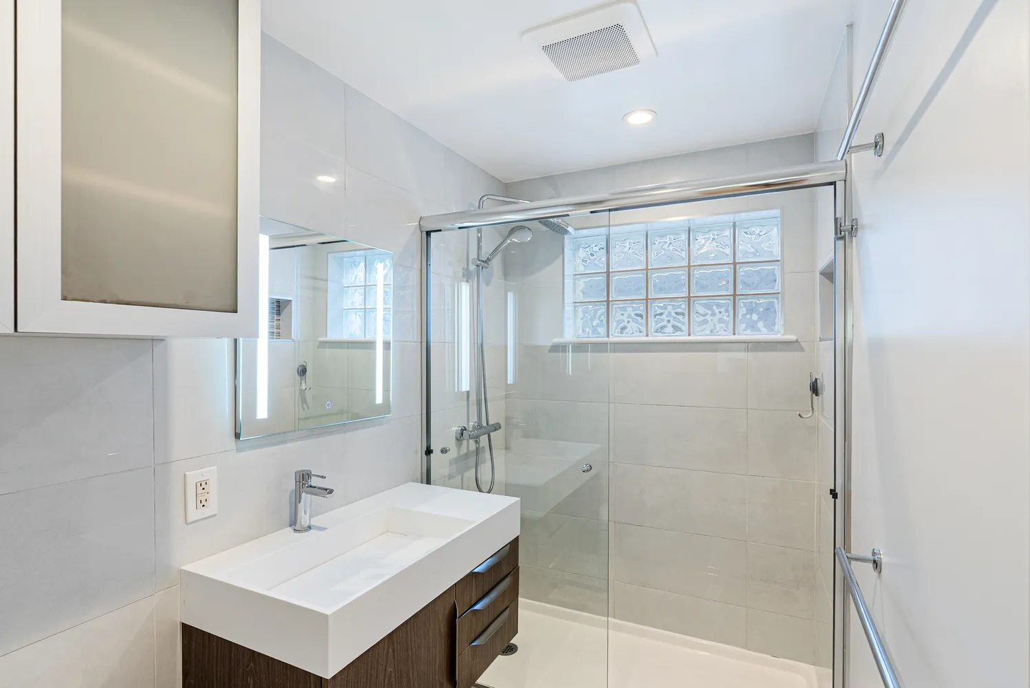 a bathroom with a sink toilet and shower