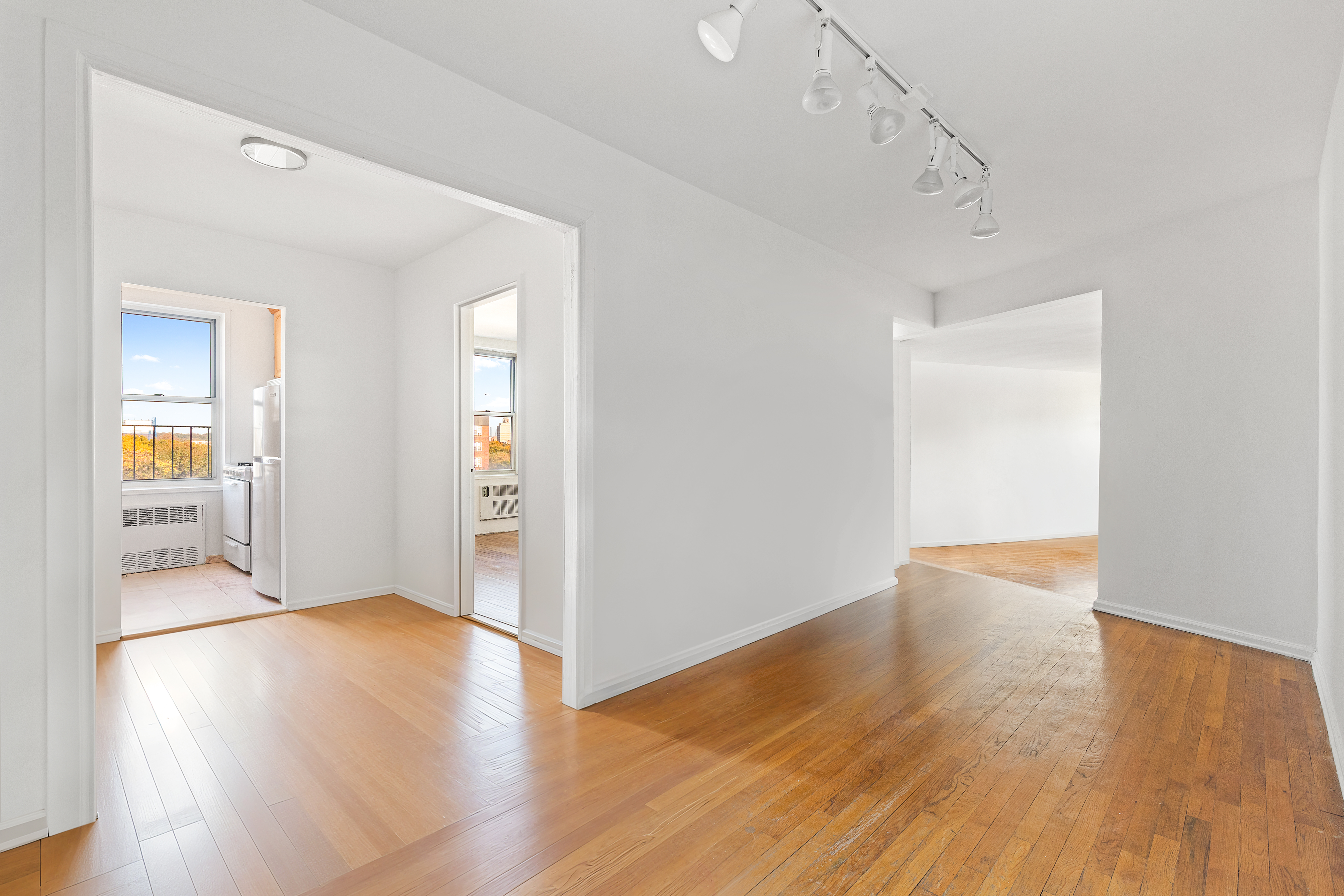 770 Ocean Parkway, Unit 6F Brooklyn, NY 11230 - Photo 6 of 17 an empty room with wooden floor and windows
