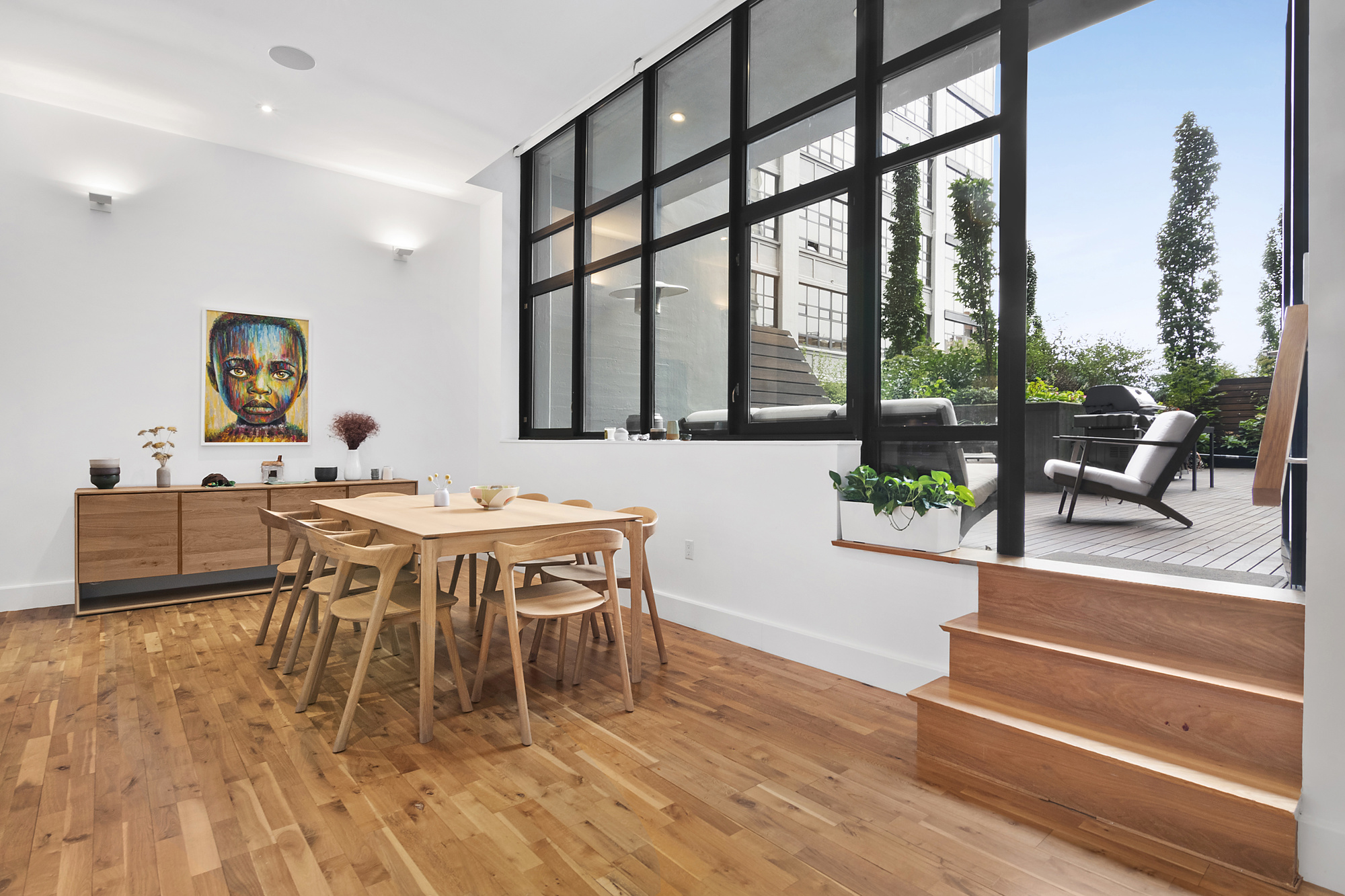 360 Furman Street, Unit 320/321 Brooklyn, NY 11201 - Photo 4 of 28 a dining room with furniture a floor to ceiling window and potted plants