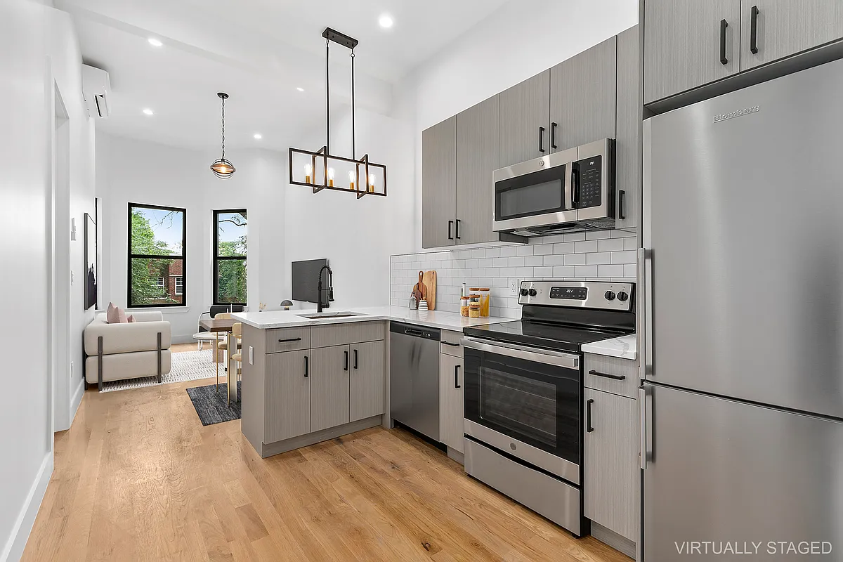 a kitchen with a sink stainless steel appliances and white cabinets