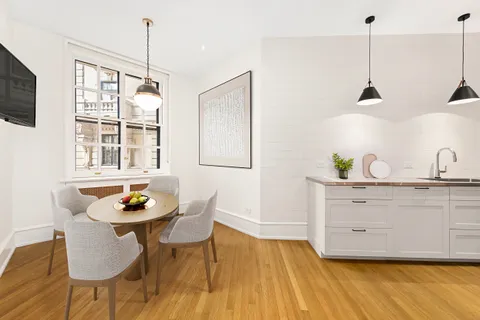 a kitchen with a table and appliances