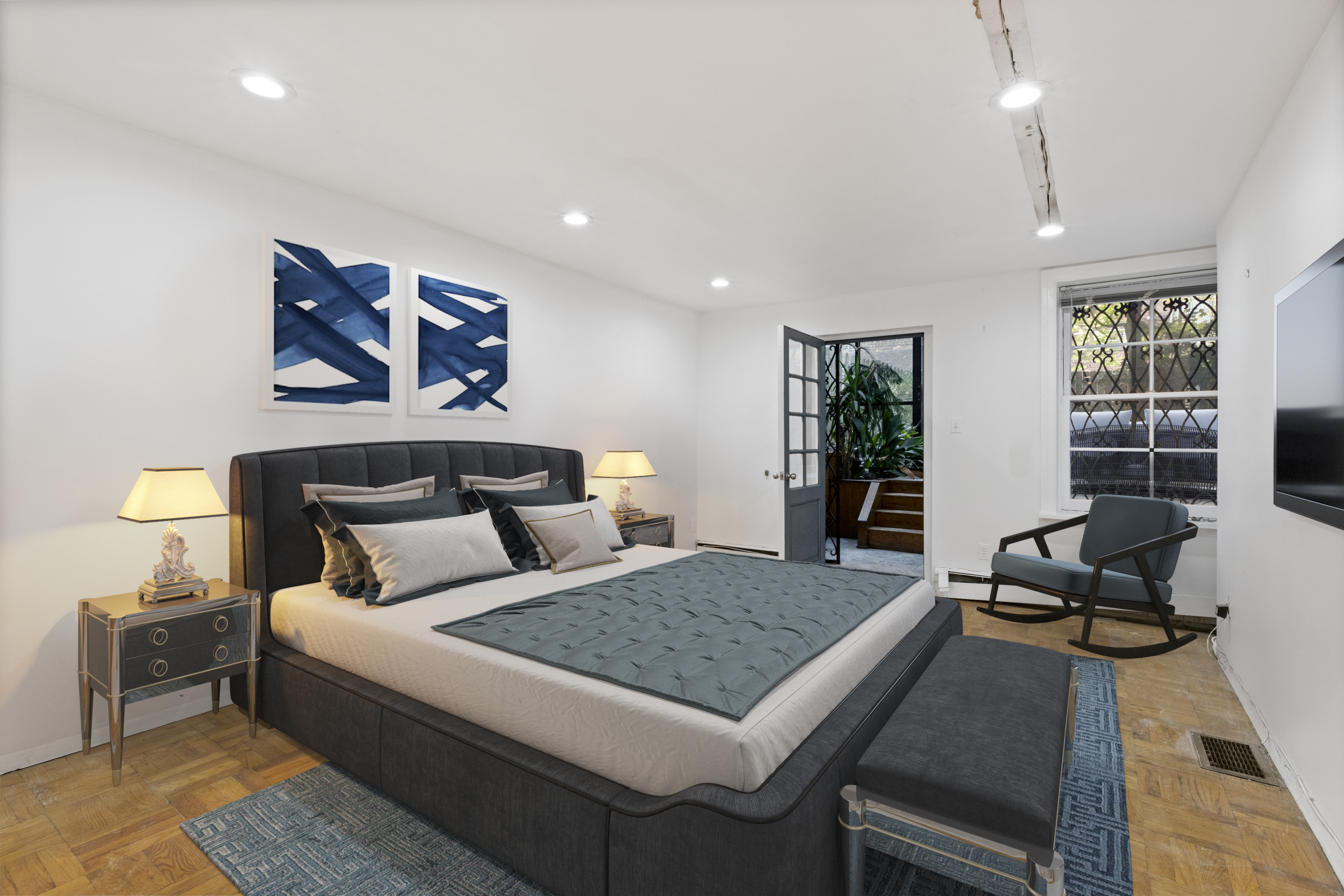 136 East 30th Street, Unit DUPLEX Manhattan, NY 10016 - Photo 18 of 26 a bedroom with a bed and glass windows