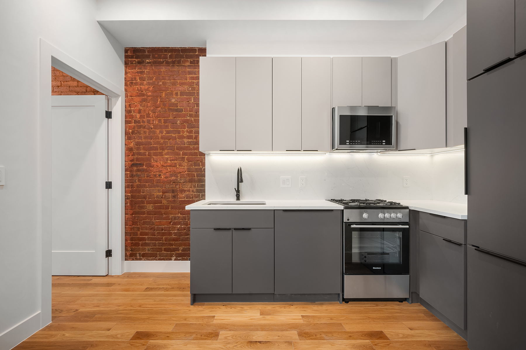 61 West 70th Street, Unit 2B Manhattan, NY 10023 - Photo 3 of 7 a kitchen with stainless steel appliances granite countertop a stove a sink and a refrigerator