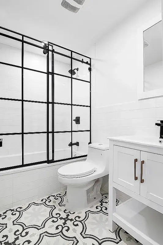 587 Van Buren Street, Unit 1 Brooklyn, NY 11221 - Photo 7 of 8 a bathroom with a sink toilet and shower