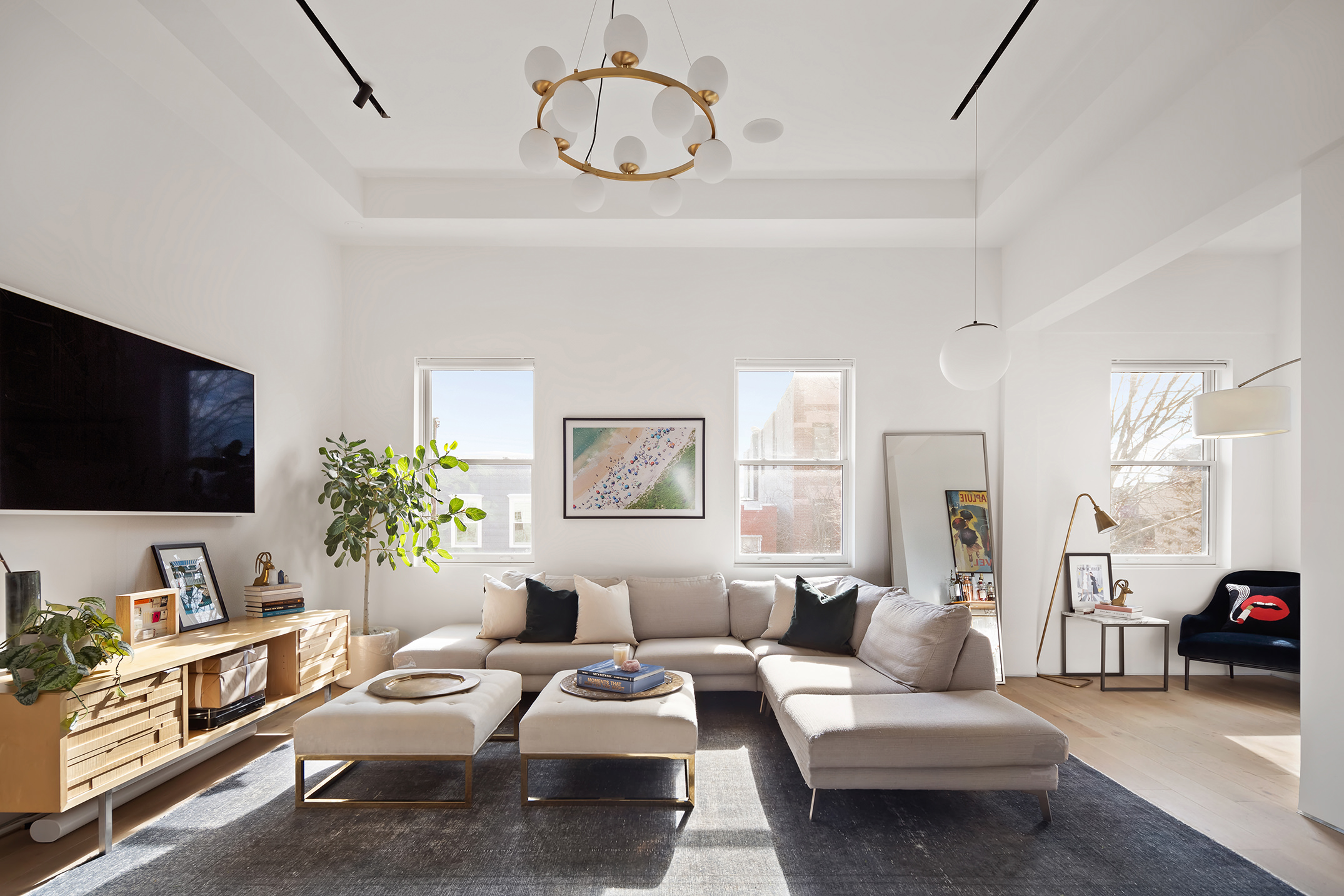 111 Noble Street, Unit 2 Brooklyn, NY 11222 - Photo 2 of 13 a living room with furniture kitchen view and a flat screen tv