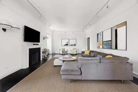 a living room with fireplace furniture and a flat screen tv