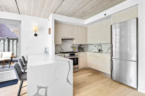 a kitchen with white cabinets and white appliances