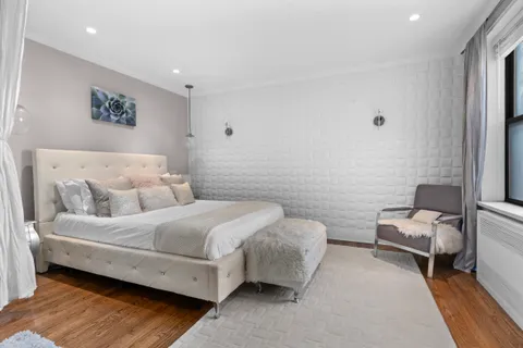 a spacious bedroom with a bed and a couch