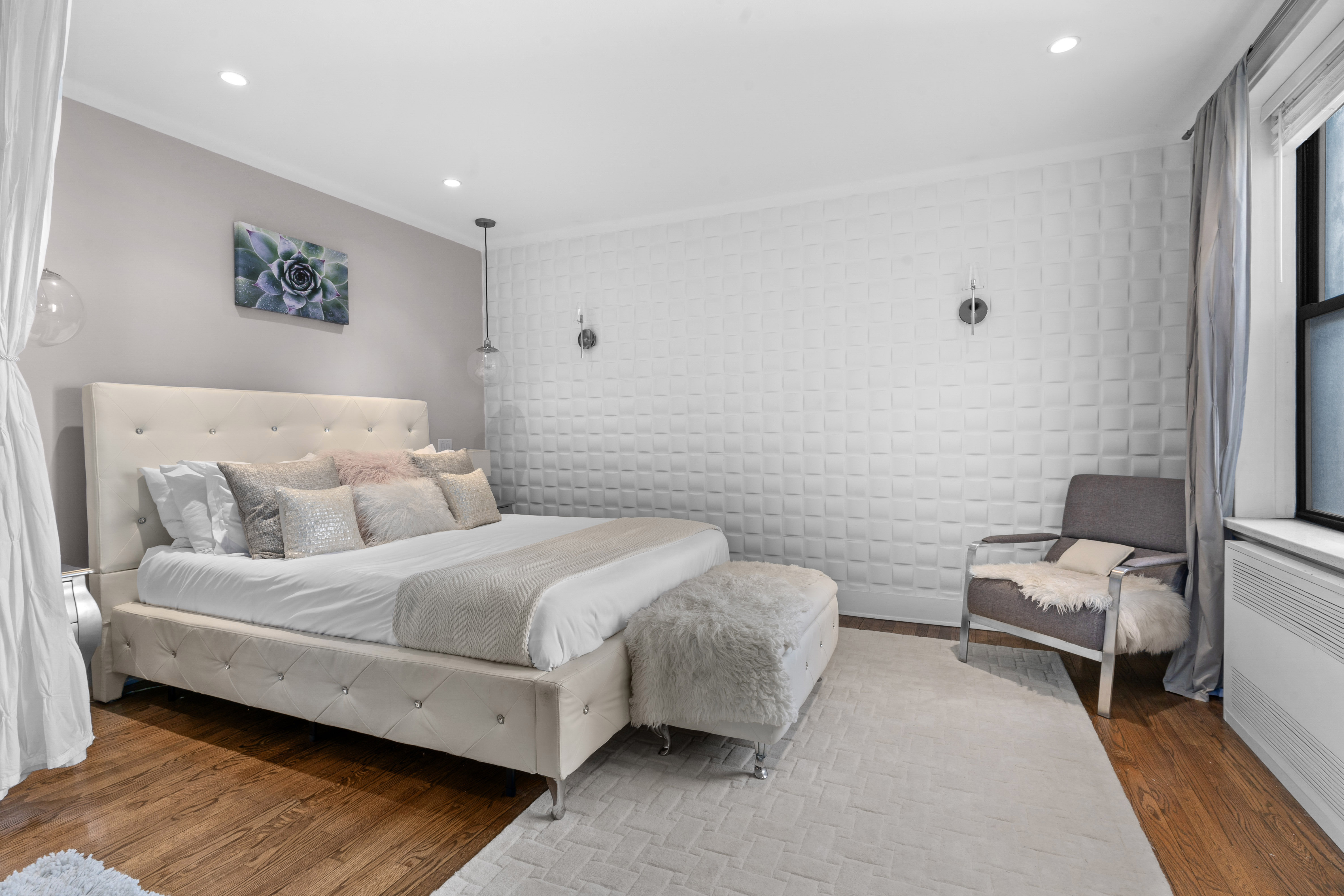 61 Oliver Street, Unit 4P Brooklyn, NY 11209 - Photo 3 of 11 a spacious bedroom with a bed and a couch