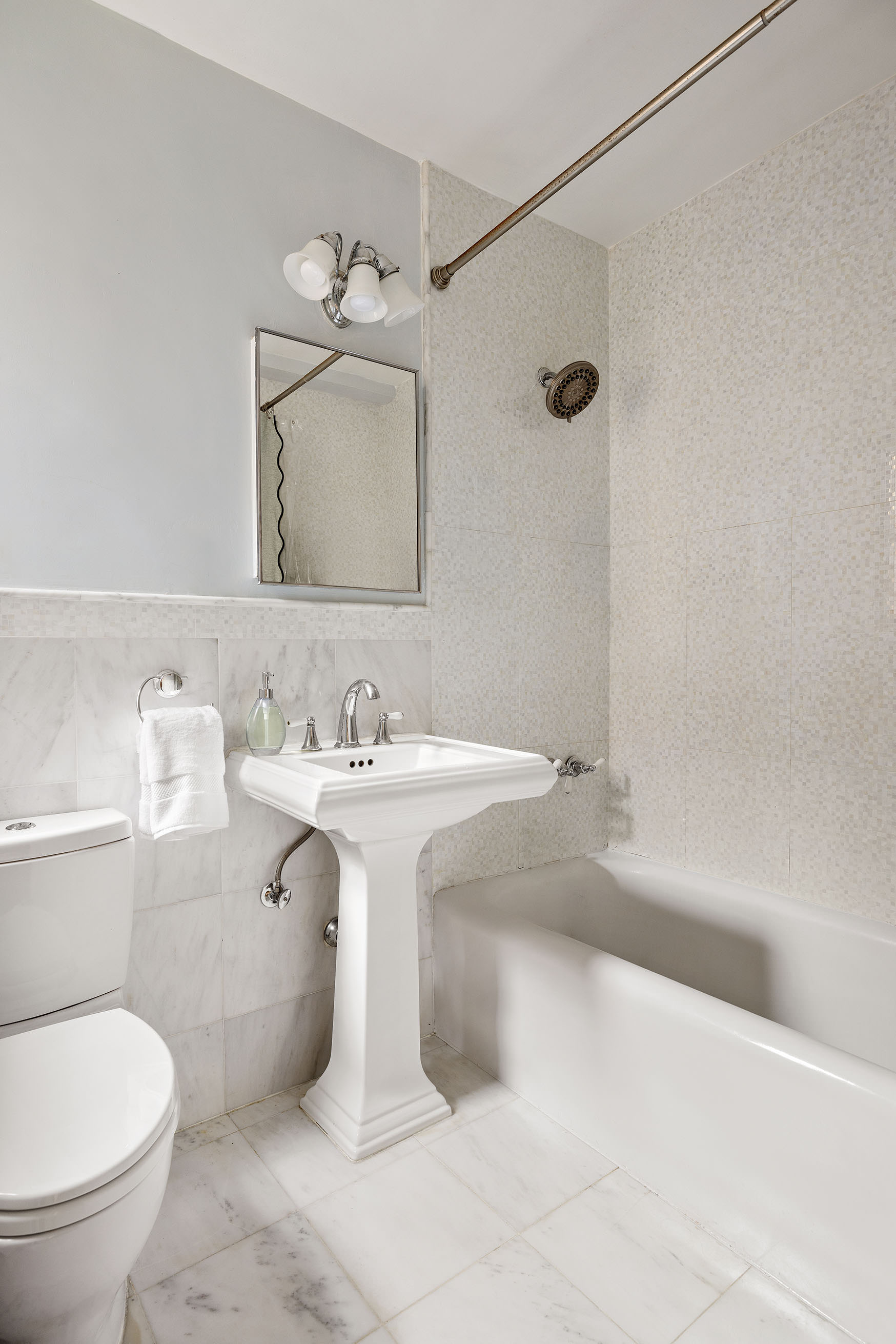 60 East 96th Street, Unit 6C Manhattan, NY 10128 - Photo 7 of 9 a bathroom with a sink toilet and shower