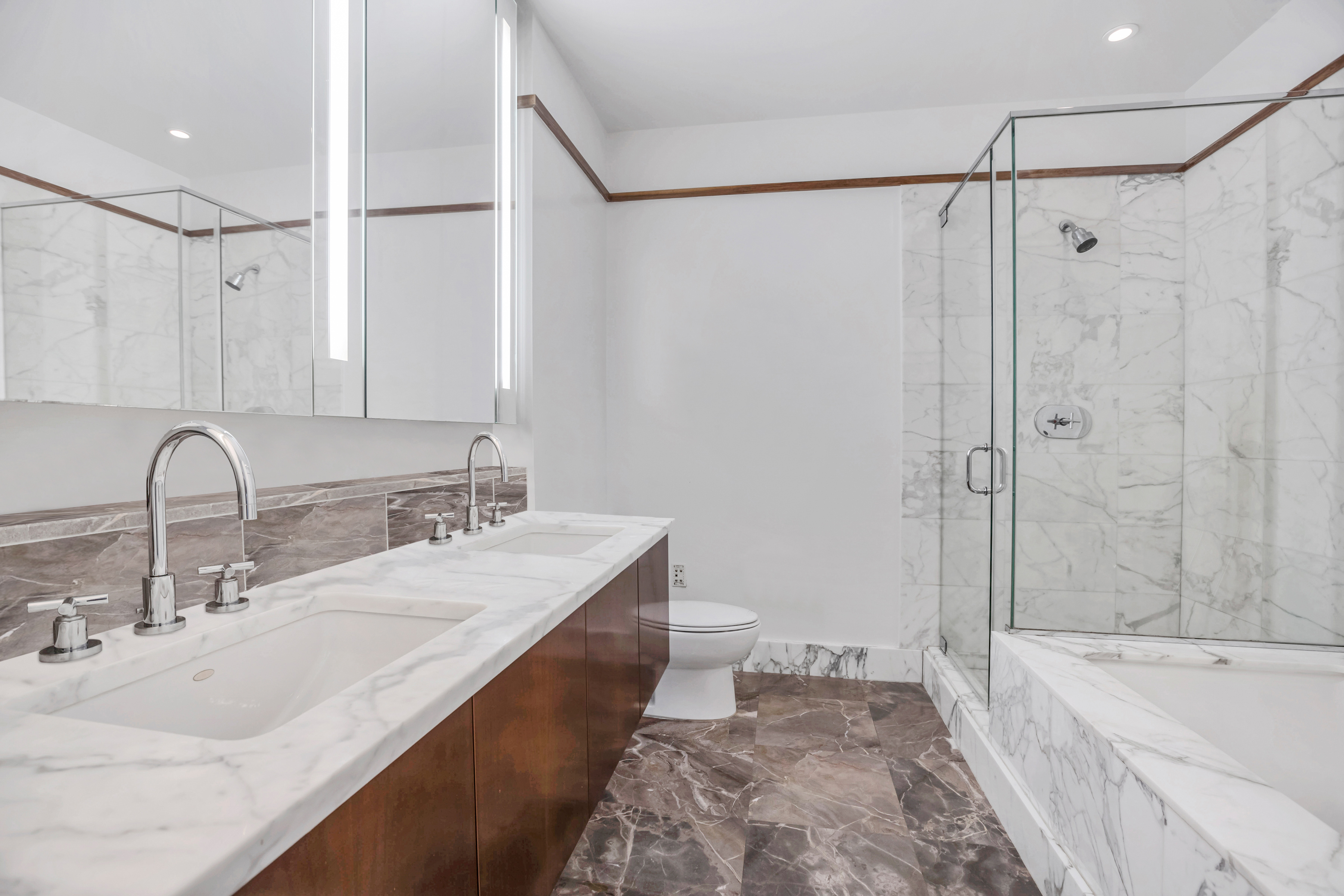 25 Columbus Circle, Unit 59F Manhattan, NY 10019 - Photo 4 of 15 a bathroom with a double vanity sink mirror double and bathtub