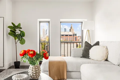 a bedroom with a bed and a potted plant