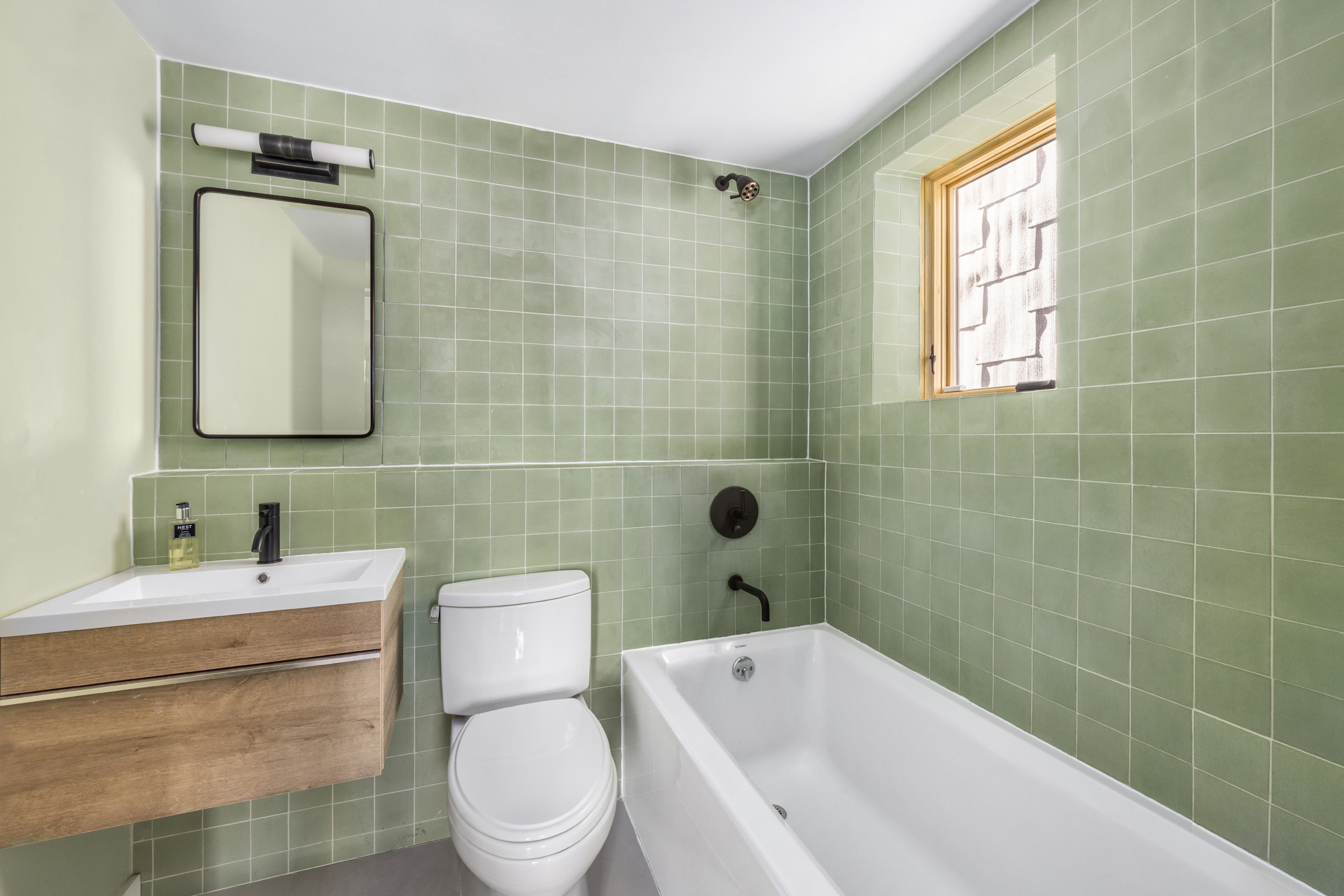 683 Leonard Street Brooklyn, NY 11222 - Photo 23 of 25 a bathroom with a toilet a sink a mirror and bathtub