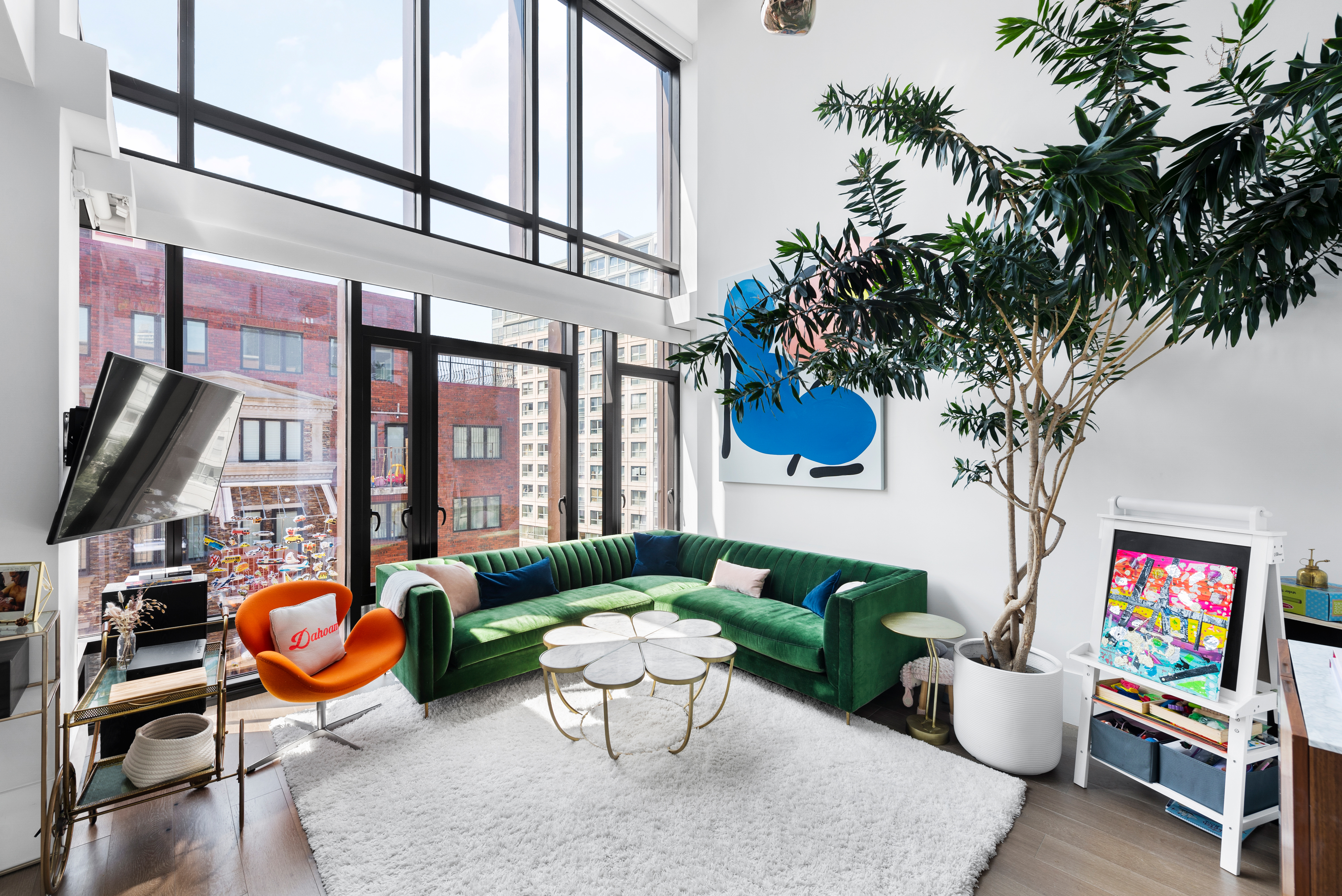 429 Kent Avenue, Unit D726 Brooklyn, NY 11249 - Photo 7 of 21 a view of a patio with couches table and chairs potted plants and a large tree