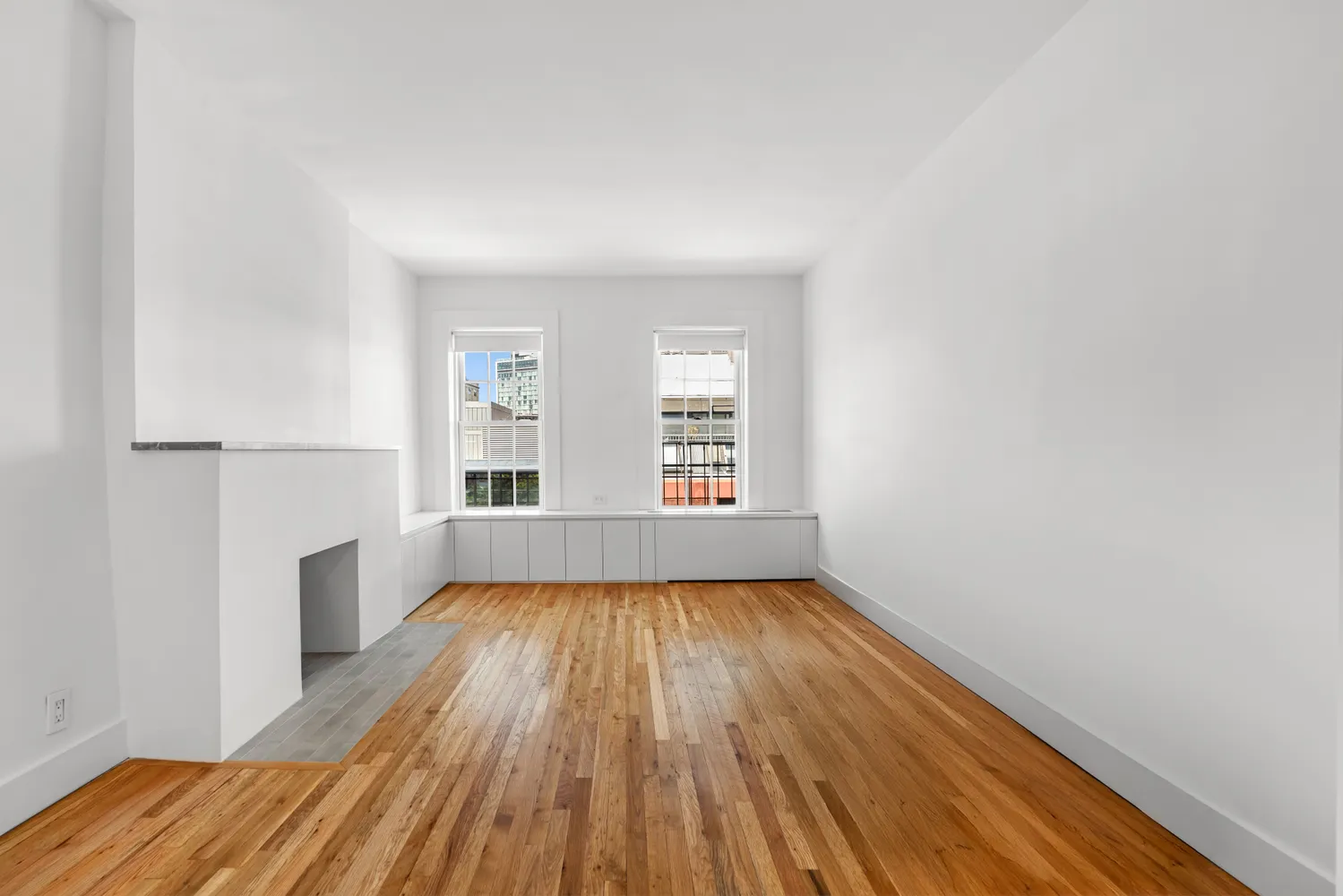 wooden floor in an empty room with a window