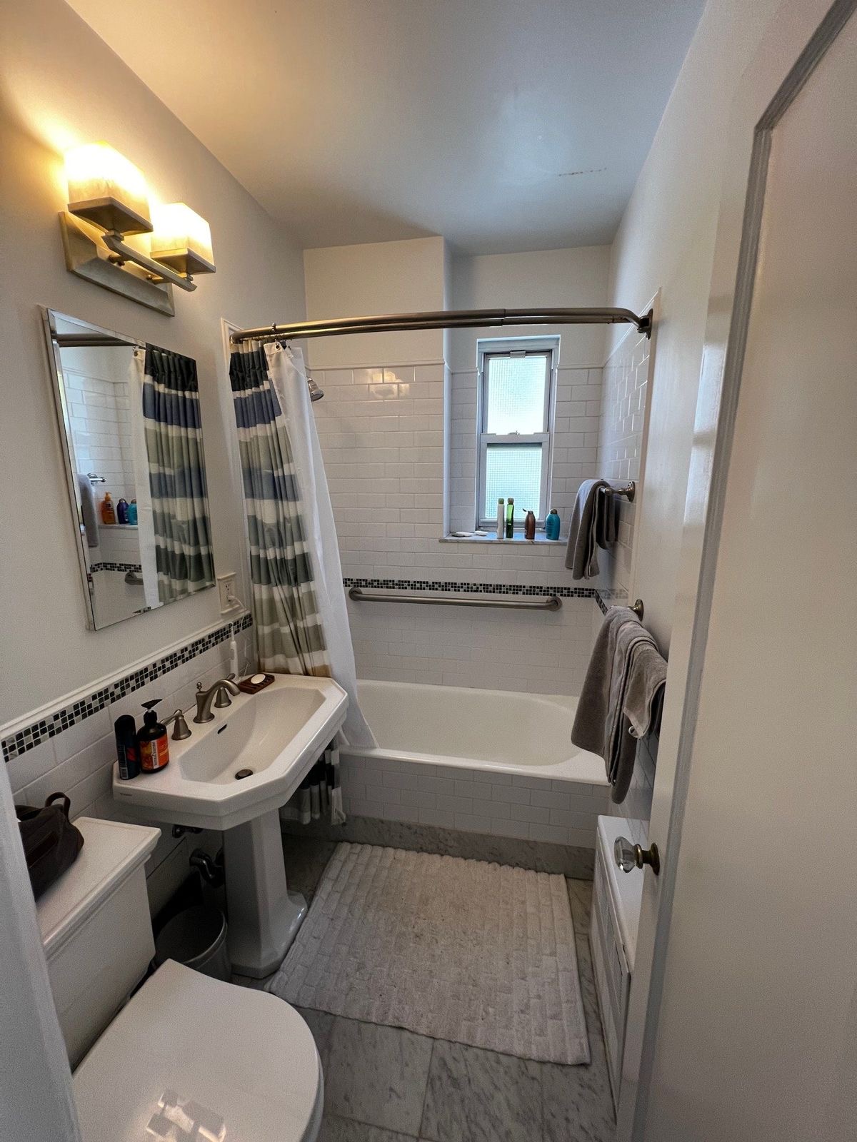 73 Perry Street, Unit 5 Manhattan, NY 10014 - Photo 9 of 10 a bathroom with a sink toilet tub and shower