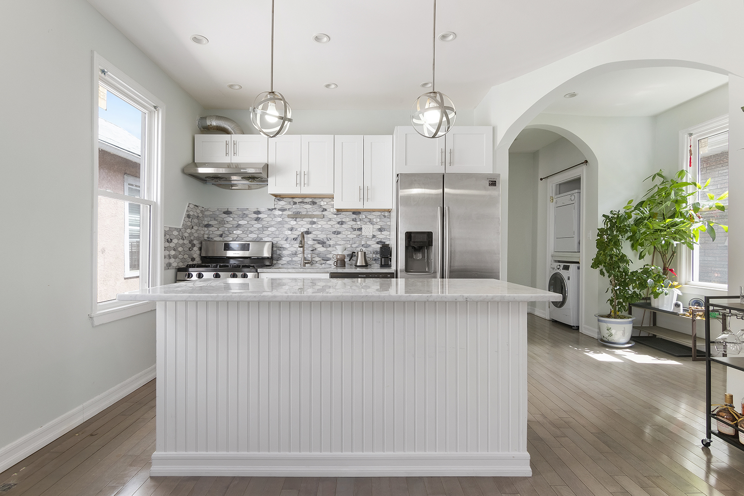 2743 Brighton 7th Street, Unit 3 Brooklyn, NY 11235 - Photo 1 of 10 a kitchen with stainless steel appliances kitchen island granite countertop a table and chairs in it
