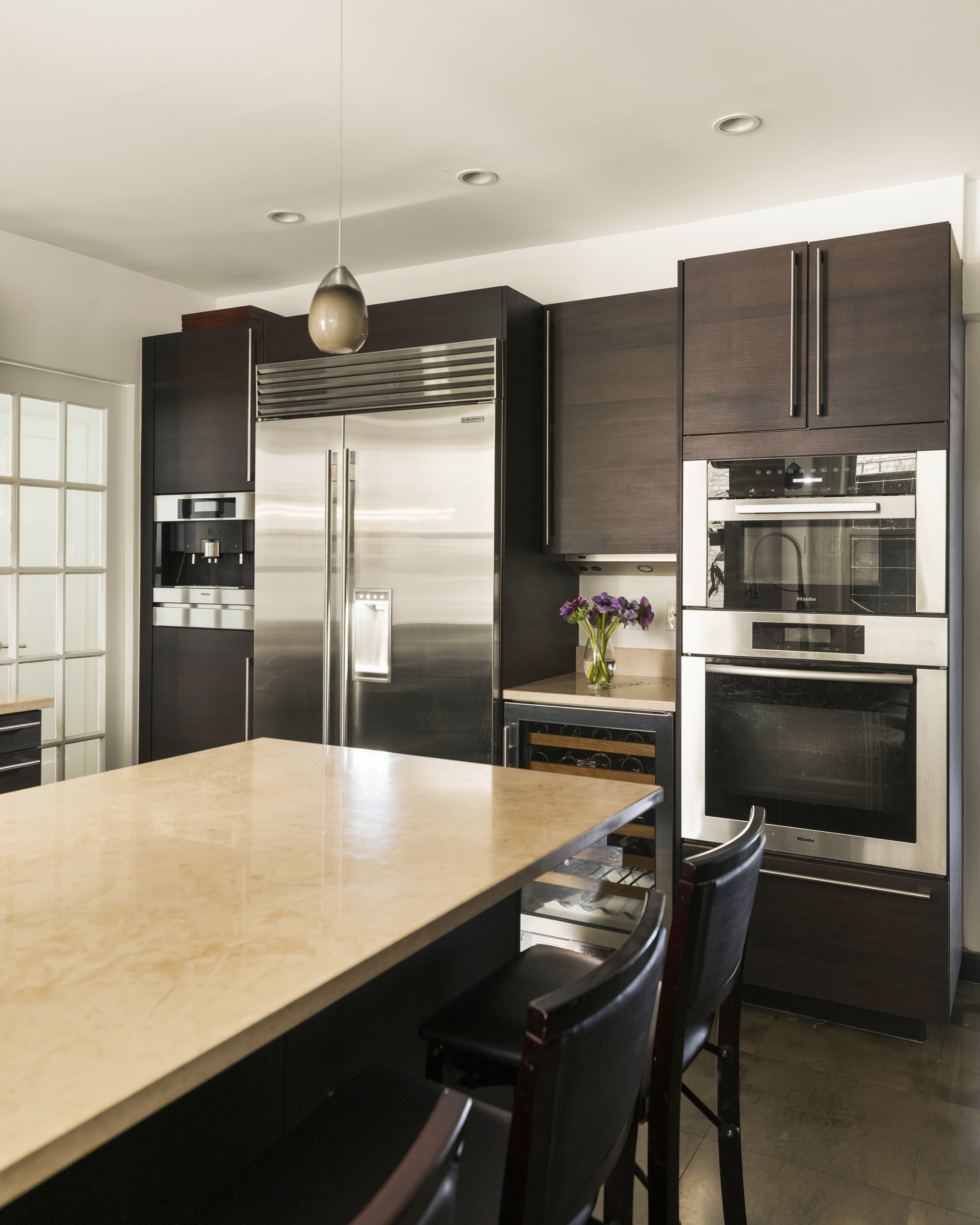 1158 5th Avenue, Unit 4A Manhattan, NY 10128 - Photo 9 of 24 a kitchen with granite countertop a refrigerator stove and oven