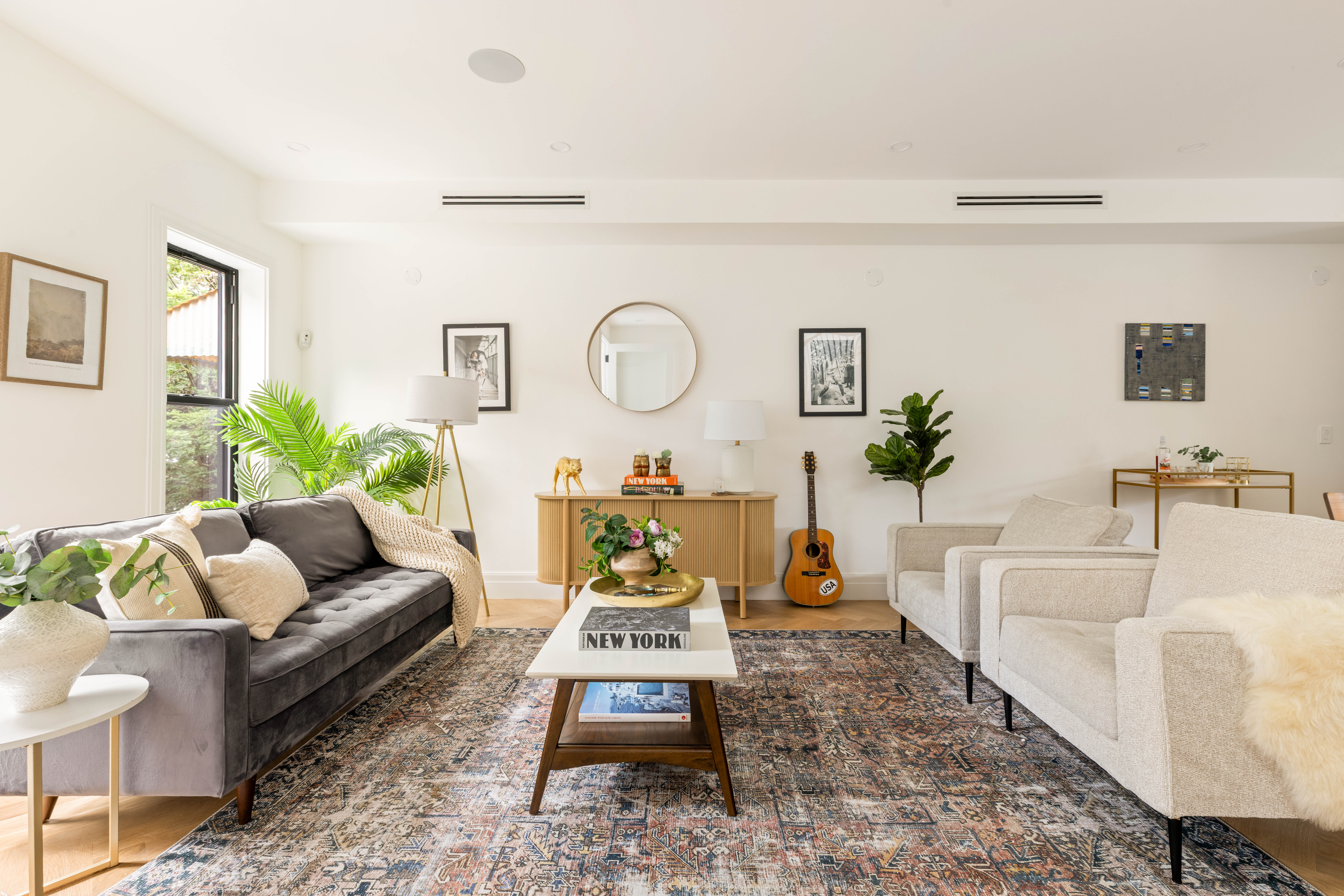 173 8th Street Brooklyn, NY 11215 - Photo 2 of 17 a living room with furniture a rug and a chandelier