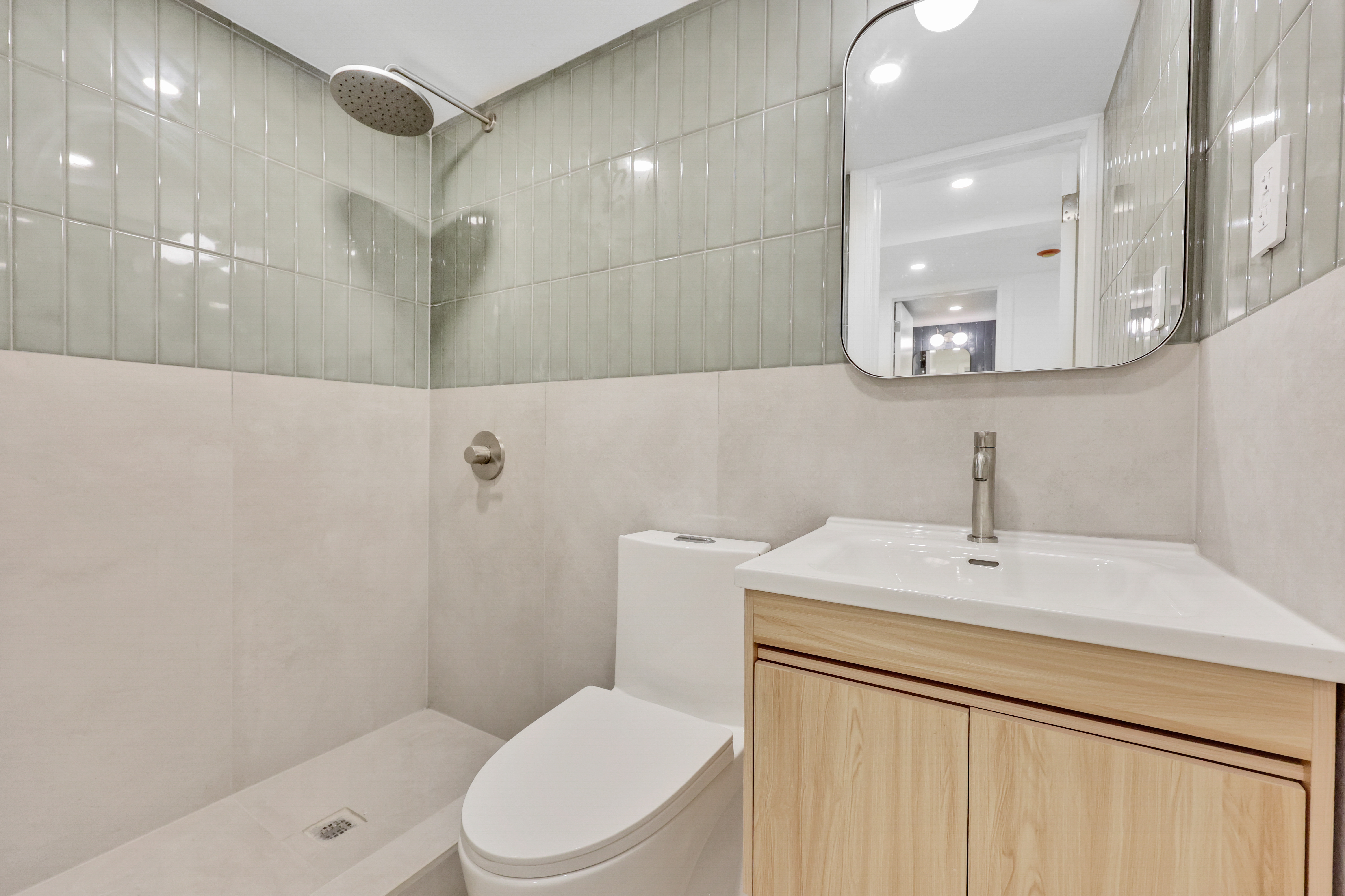 84 Pilling Street, Unit 1 Brooklyn, NY 11207 - Photo 6 of 14 a bathroom with a sink a toilet a mirror and vanity