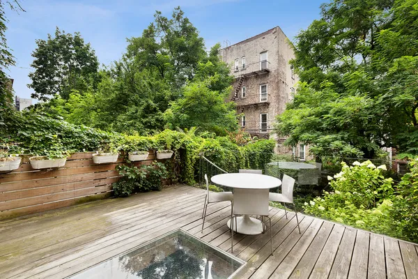 a view of a table and chairs in patio with potted plants